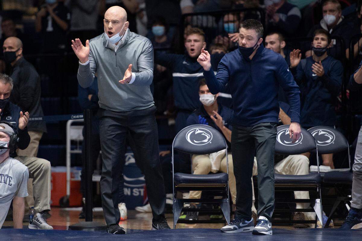 Penn State head coach Cael Sanderson and Penn State assistant coach Cody Sanderson yell during a wrestling dual between Penn State and Rutgers on Sunday, Jan. 16, 2022 at Rec Hall in University Park, Pa. Penn State defeated the Scarlet Knights 27-11.