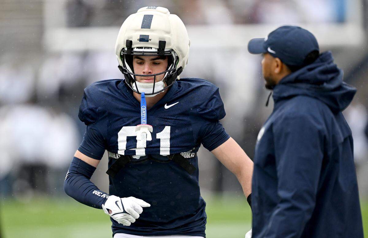 Penn State wide receiver Ben Whitver runs a drill as wide receivers coach Kashif Moore watches during the Blue-White Practice on Saturday, April 25, 2026.  