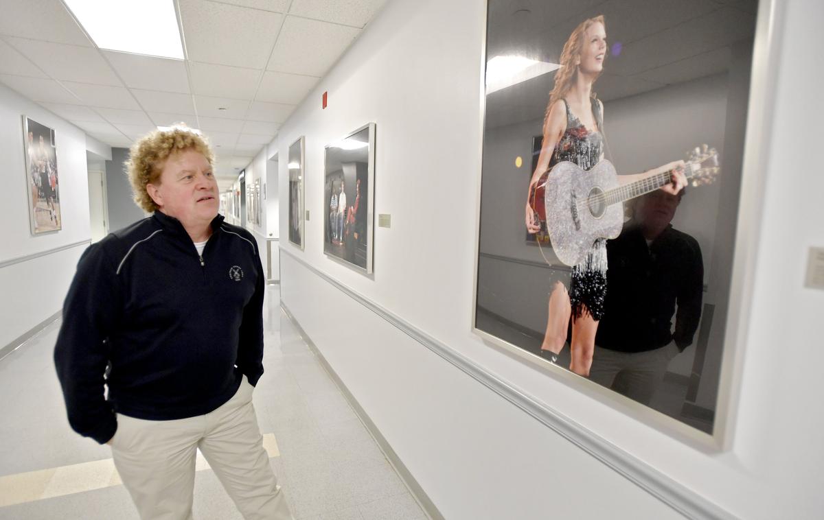 Bernie Punt shares a story about Taylor Swift coming to perform in the Bryce Jordan Center as he walks down a hall a of the building filled with photos from past shows on Thursday, Jan. 10, 2019.
