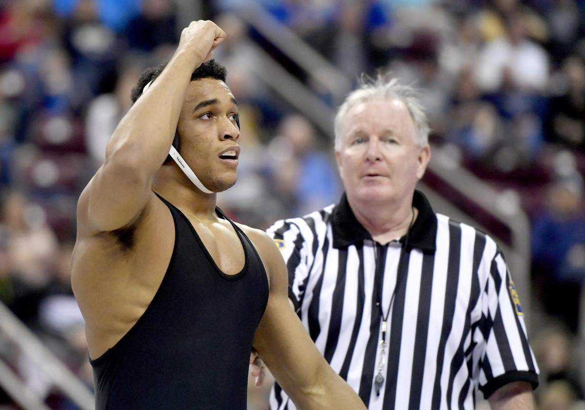 Cathedral Prep’s Carter Starocci celebrates his win over Mt. Lebanon’s Luke Stout in the 182 lb championship bout at the PIAA AAA wrestling championships at the Hershey Giant Center on Saturday, March 9, 2019.