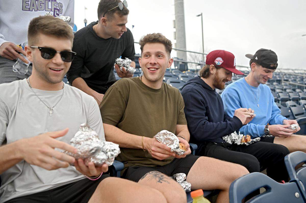 Spencer Hofman laughs as he and his friends enjoy dollar dog night at the Penn State baseball game on Tuesday, April 11, 2023 at Medlar Field.