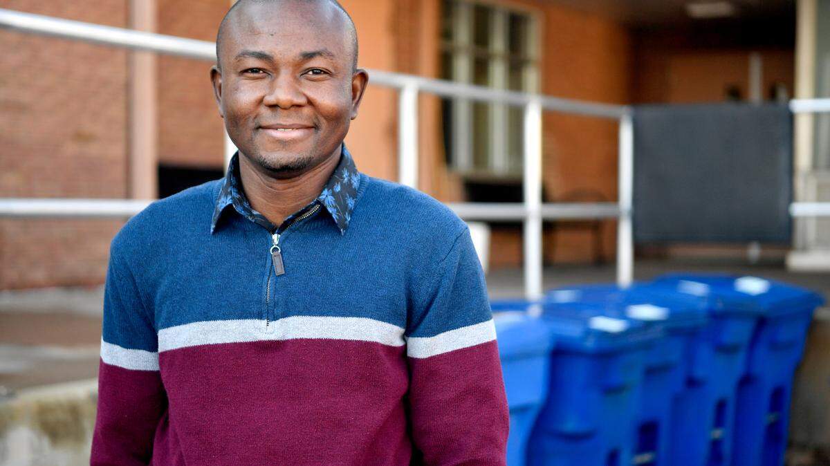 Ayodeji Oluwalana, Penn State office of physical plant’s first reduction and recycling program manager, poses outside of the OPP building on April 8.