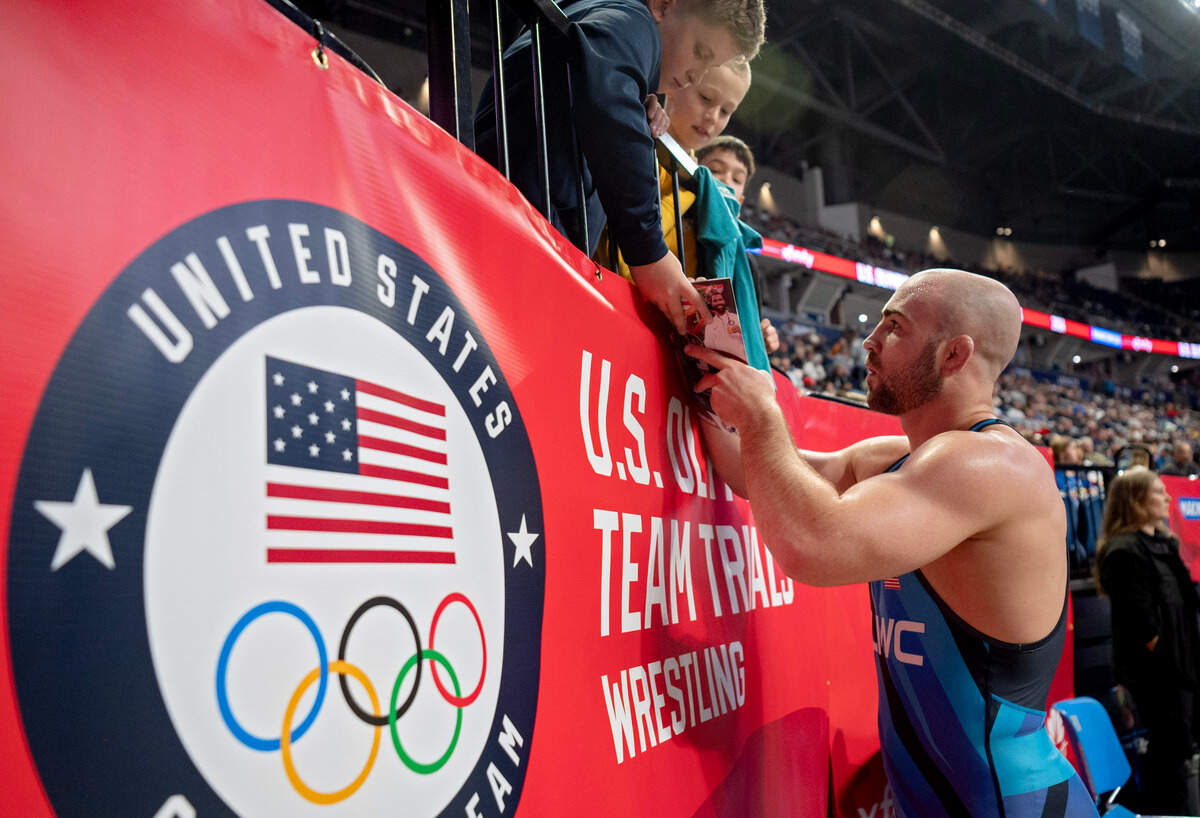 Max Dean signs autographs for a group of fans after his 86 kg win over Connor Mirasola during the U.S. Olympic Team Trials at the Bryce Jordan Center on Friday, April 19, 2024.