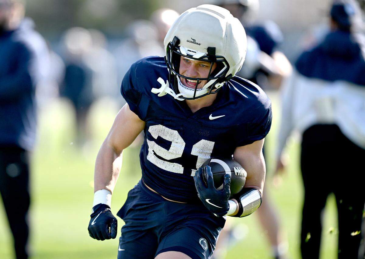 Penn State running back Carson Hansen smiles as he runs a play during practice on Thursday, April 9, 2026.  