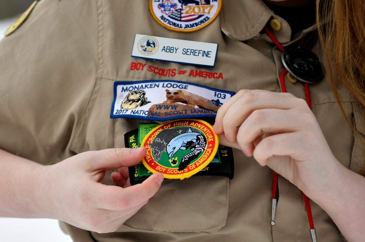 Abby Serefine shows off one of her patches that she completed, the Boy Scouts of America triple crown of high adventure.