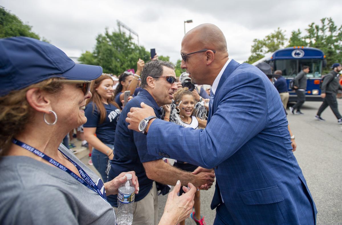 Penn State football coach James Franklin greets the Rosenberg family as the football team arrives for the season opener against Appalachian State at Beaver Stadium on Saturday, September 1, 2018.