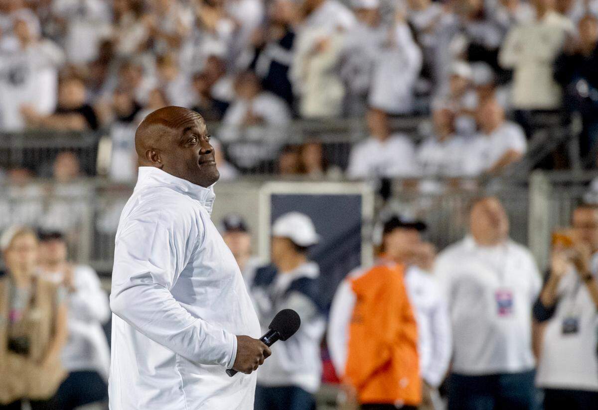 Ki-Jana Carter tries to pump up the crowd as he and members of the Penn State 1994 football team are honored during the game against Illinois on Saturday, Sept. 28, 2024.