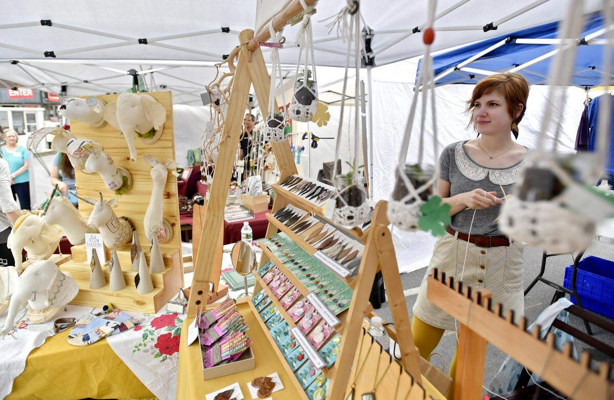 Molly Cahill of MollyauContraire knits as visitors browse her stand at Pop Up Ave in April 2017 in downtown State College. MollyauContraire will again return for the 2025 Pop Up Ave.