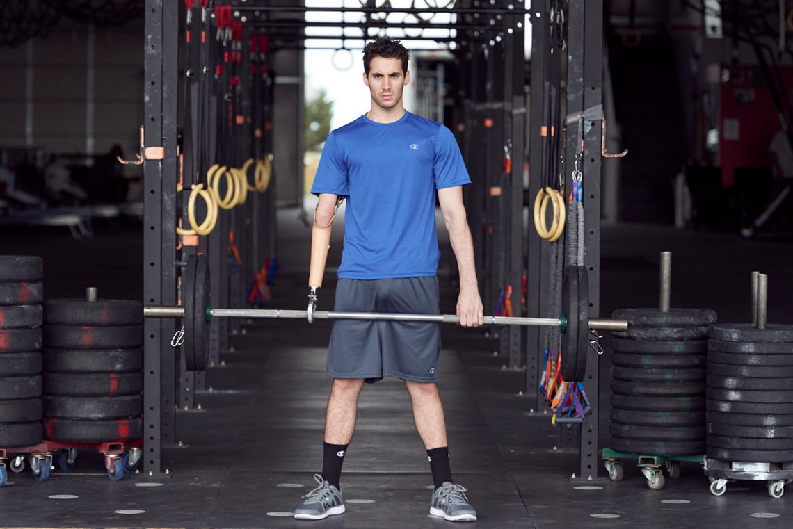Julian W. Lucas lifts weights for a Champion clothing brand photo shoot. Lucas is a model and actor who advocates for more visibility among people with disabilities.