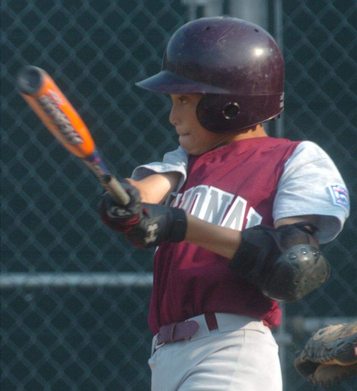 State College National’s Spencer Bivens hits a single with 2 outs against State College American in the 1st inning during their Little League playoff game on Monday, July 9, 2007.