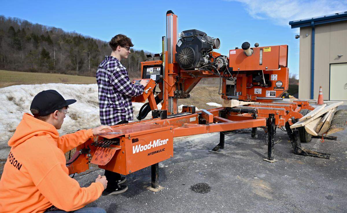 Seniors Jacob Richardson and Carnell Noone work together to mill wood outside of the new forestry building on Thursday, Feb. 26, 2026. 