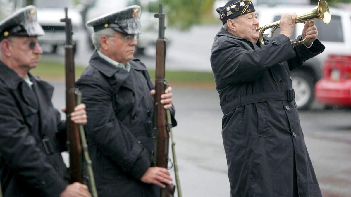 John Saylor, from American Legion Post 33 in Bellefonte, plays taps on the bugle during a service in memory of the Sept. 11, 2001, terror attacks, outside of the State College Veterans Clinic on Friday, Sept. 11, 2009.
