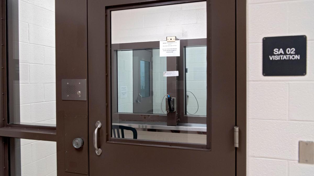 One of the standard visiting rooms in the Centre County Correctional Facility, where inmates and visitors are separated by glass and use a phone to talk.