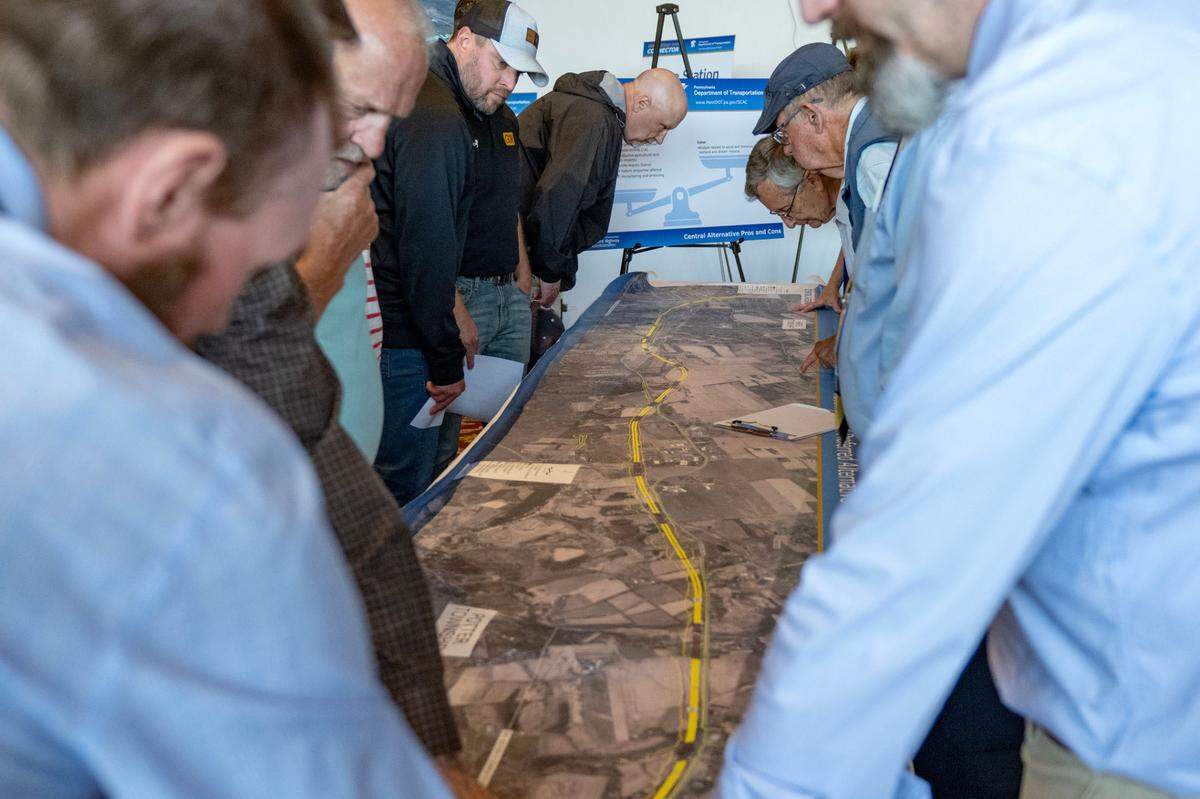 Community members look at a map of the central alternative route for the State College Area Connector project from PennDOT during a public scoping meeting on Thursday, May 9, 2025 at the Wyndham Garden State College.