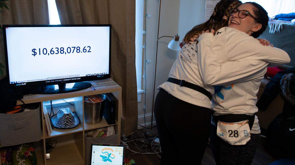 Natalie Ondrey, right, and Brooke Schindelheim hug Sunday during the Thon total reveal. Dancers participated in the annual event, which raises money for the Four Diamonds childhood cancer charity, remotely this year due to the pandemic.