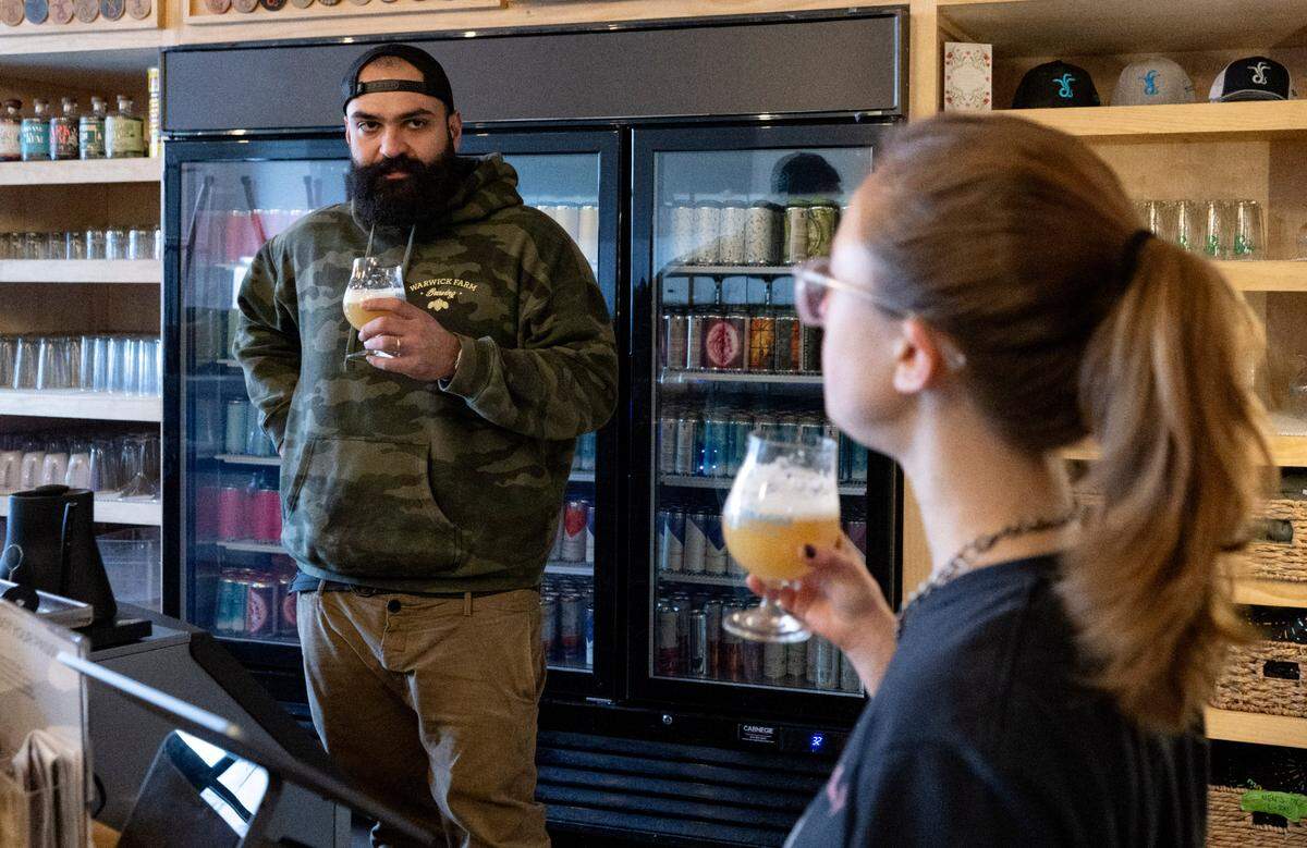 Head brewer at Antifragile Brewing Company Paulo Nami talks with kombucha brewer Katie Legenski as they taste test Optionality #22 on Tuesday, Nov. 28, 2023.