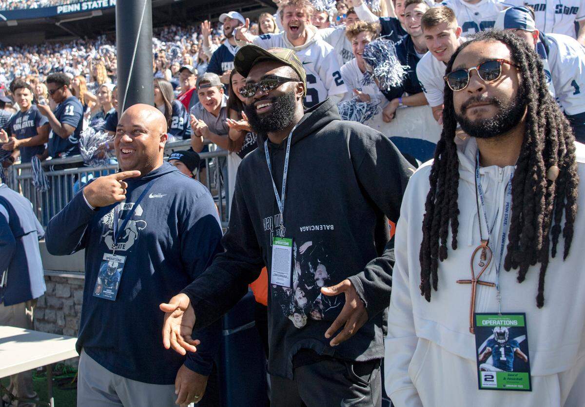 Penn State basketball coach Micah Shrewsberry points to Celtics basketball player Jaylen Brown as he tries to pump up the crowd during the Penn State football game against Central Michigan on Saturday, Sept. 24, 2022.
