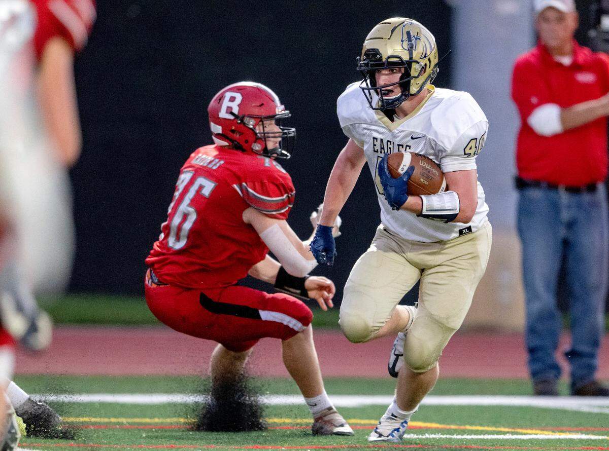 Bald Eagle Area’s Wyatt Spackman cuts around Bellefonte defenders to score a touchdown during the game on Friday, Sept. 9, 2022.