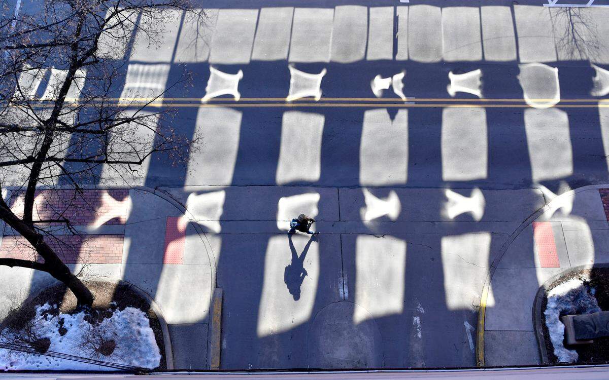 A pedestrian walks through the shadows of the Pugh Street garage on March 2.