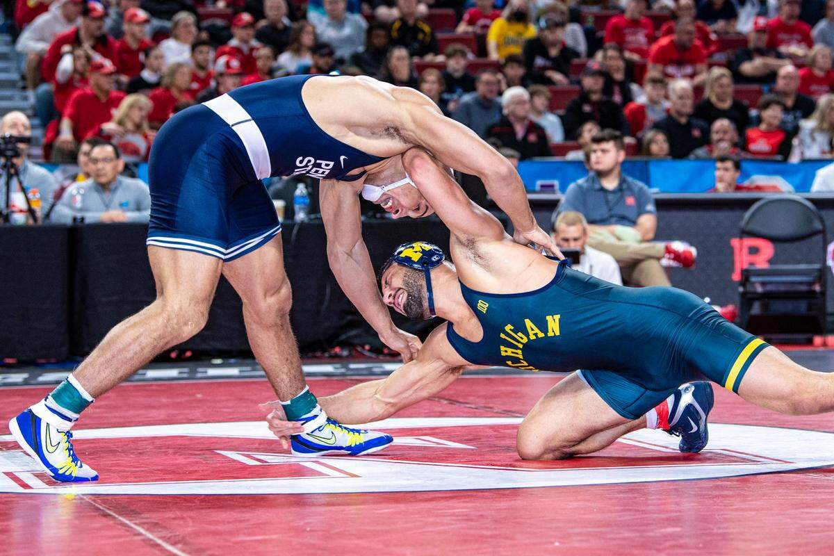 Michigan’s Myles Amine scores the winning takedown on Penn State’s Aaron Brooks in their 184-pound finals of the Big Ten Championships on Sunday, March 6, 2022 in Lincoln, Neb. Brooks fell to Amine, 6-4, in sudden victory.