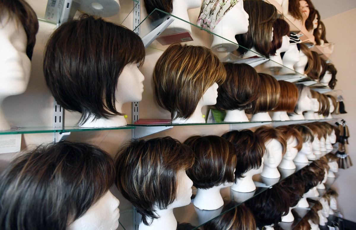 Wigs are lined up and on display at The Hair Lady boutique Thursday, Aug. 23, 2018 in State College.