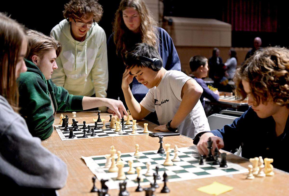 Players gather around to watch a match during the State College Area School District chess tournament on Tuesday, Feb. 20, 2024.