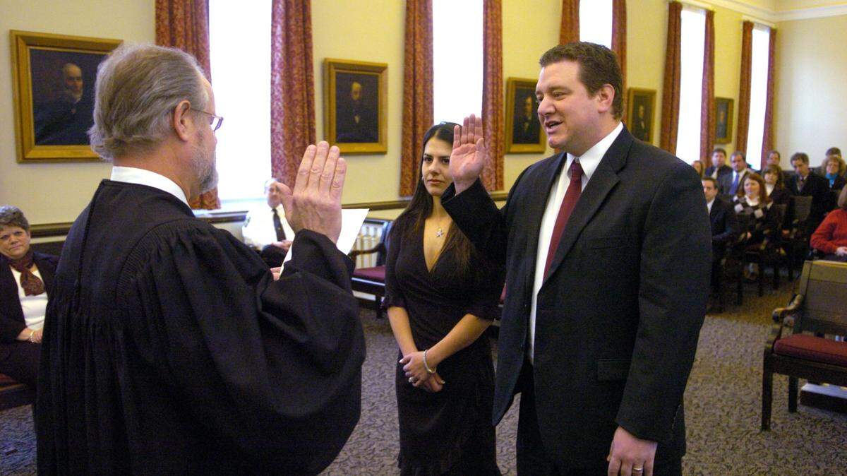 Judge David E. Grine swears in Jonathan Grine as Magisterial District Judge in 2010 at the Centre County Courthouse in Bellefonte.