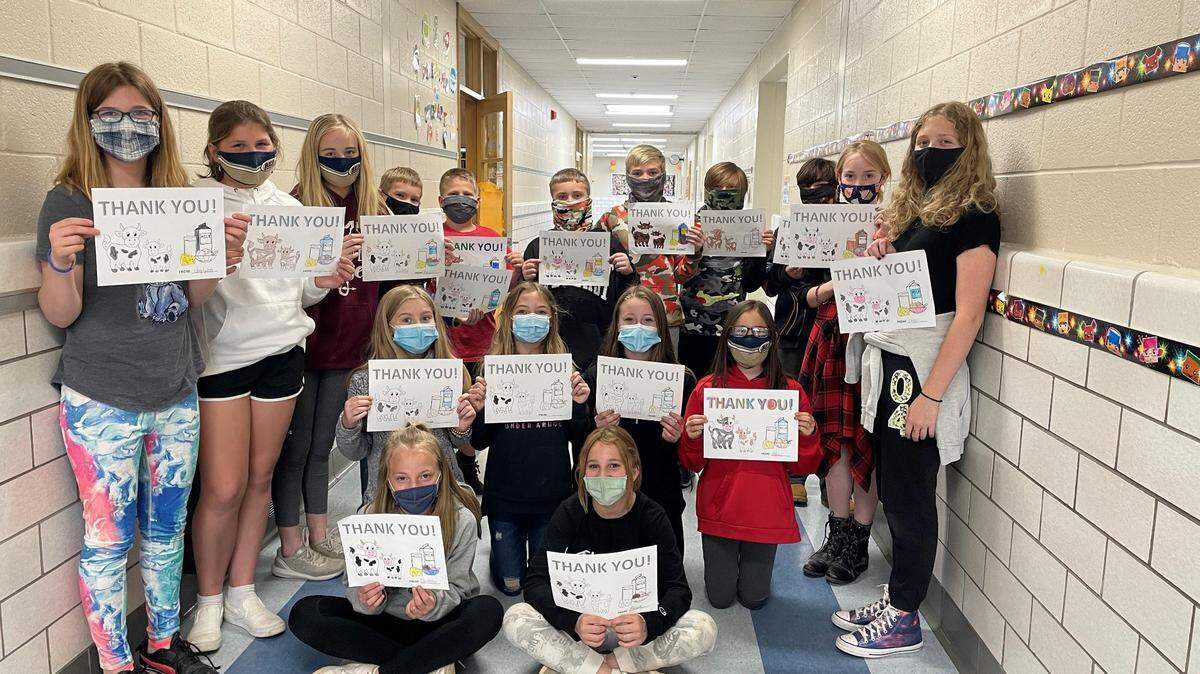Fifth-graders at Bald Eagle Area School District hold up thank you notes to dairy farmers.