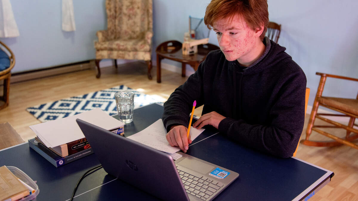 Kyle Hynes, a State College Area High School senior, attends his chemistry class from his family’s State College home on Tuesday, March 23, 2021.