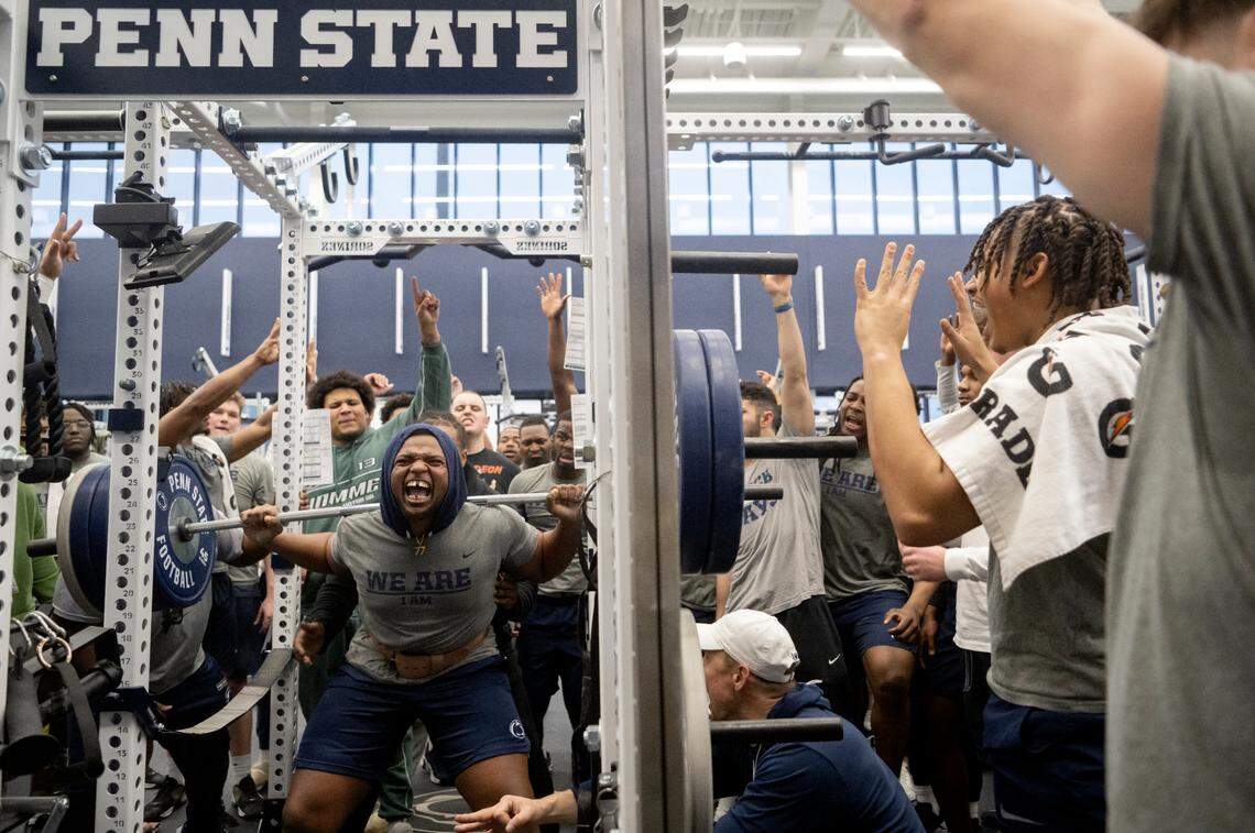 Teammates cheer on Penn State offensive lineman Sal Wormley as he squats during a max-out lifting session on Thursday, March 2, 2023.