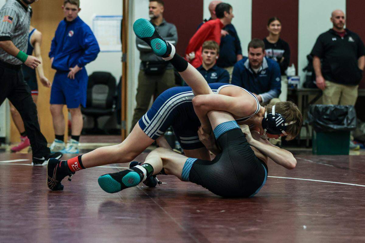 Penns Valley’s Evan Lisowski locks up a cradle on Penn Cambria’s Brycen Hursh in their 107-pound quarterfinals match of the District 6 Class 2A Championships on Friday in Altoona. Lisowski pinned Hursh in 41 seconds.