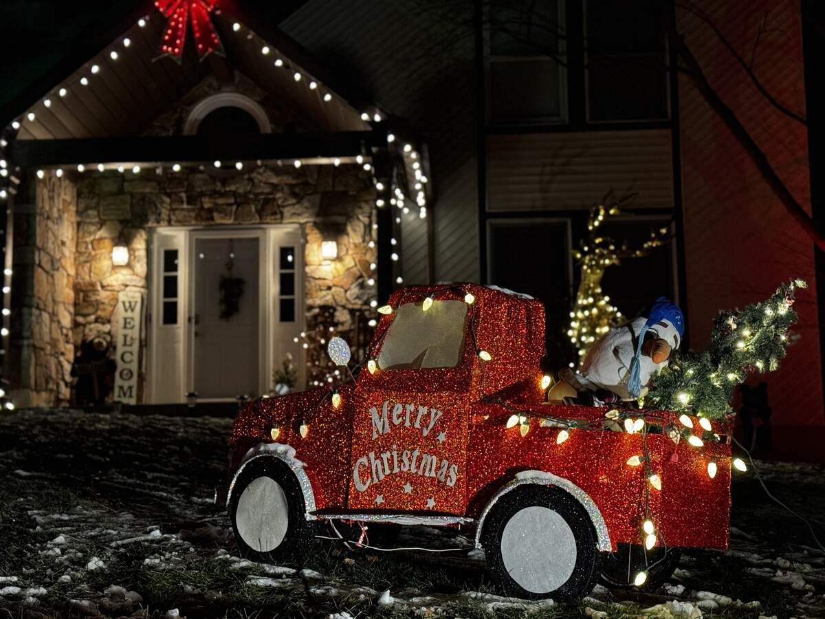 A red truck decoration carries Olaf the snowman and a Christmas tree in its bed at 521 Squirrel Drive, State College, on Dec. 4, 2025.