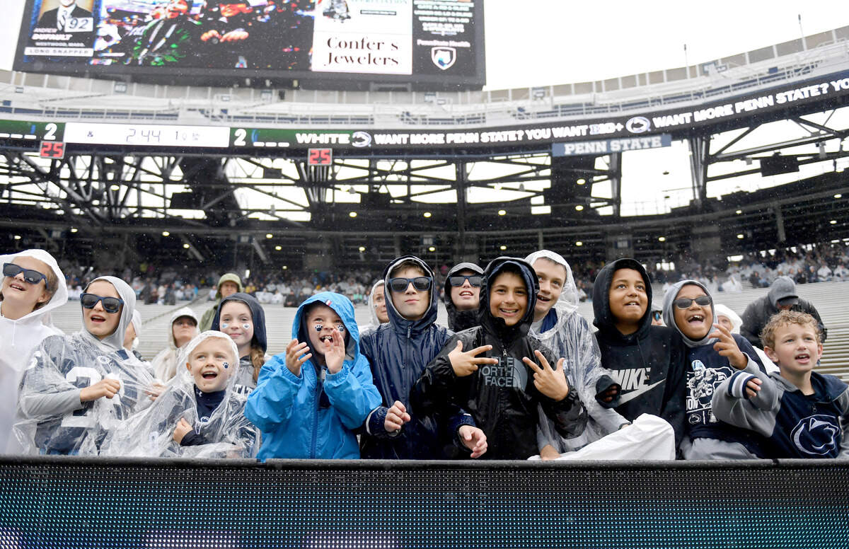 Young Penn State fans brave the rain to cheer on the team during the Blue-White Practice on Saturday, April 25, 2026 in Beaver Stadium.