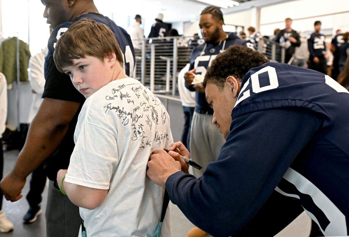 Levi Krodel, 11, has Penn State football players and coaches sign his T-shirt during the Thon Explorers event at the Lasch Building on Saturday, Feb. 21, 2026.  