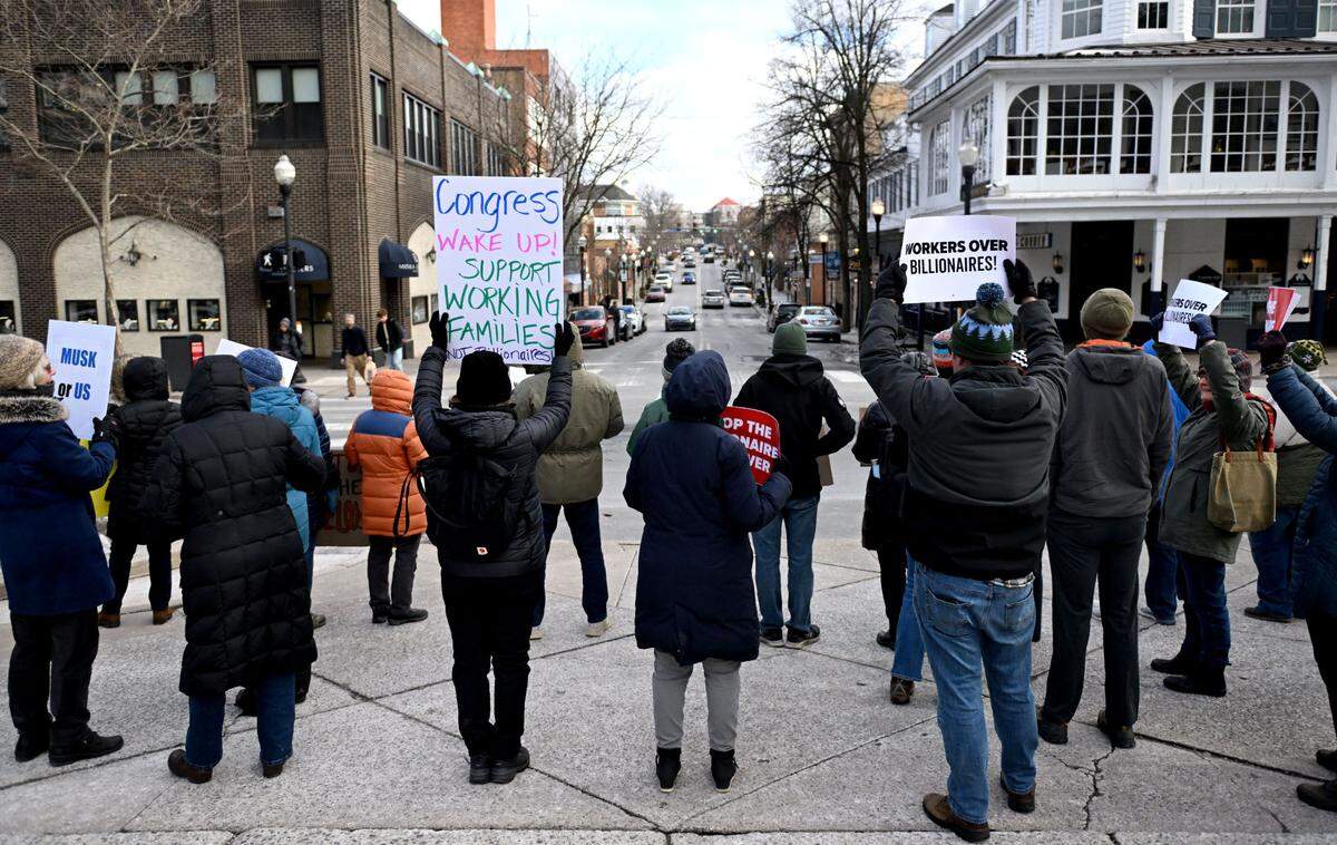 Community members rally support for working families on Friday, Feb. 21, 2025 at the Allen Street gates.