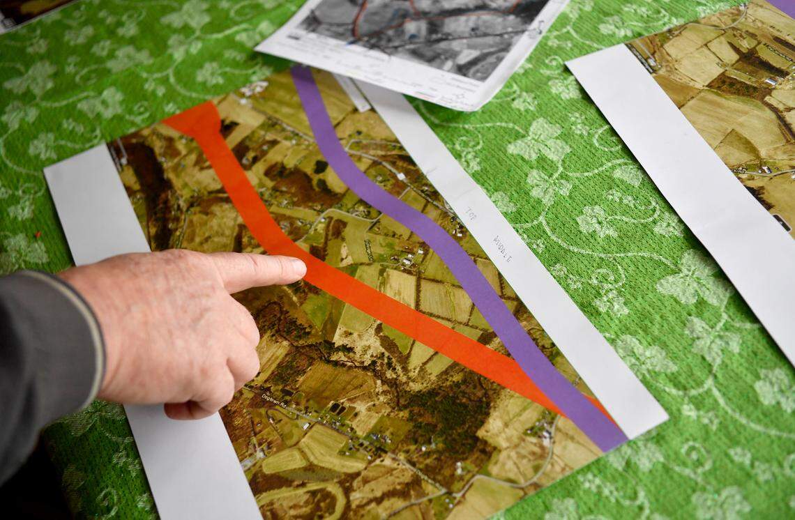 Jesse Darlington shows how one of the proposed State College Area Connector routes would cut through the middle of his farm, separating his fields and animals.