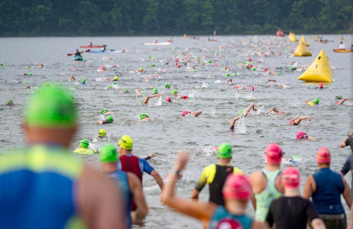 Athletes set off on the 1.2 mile swim in Foster Joseph Sayers Lake at Bald Eagle State Park for the Ironman 70.3 Pennsylvania Happy Valley on Sunday, June 30, 2024.
