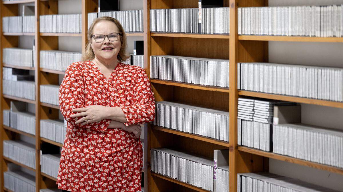 Cindy Hahn, the executive director of C-NET, stands along a wall of archives in the C-NET office on Tuesday, May 12, 2026.  