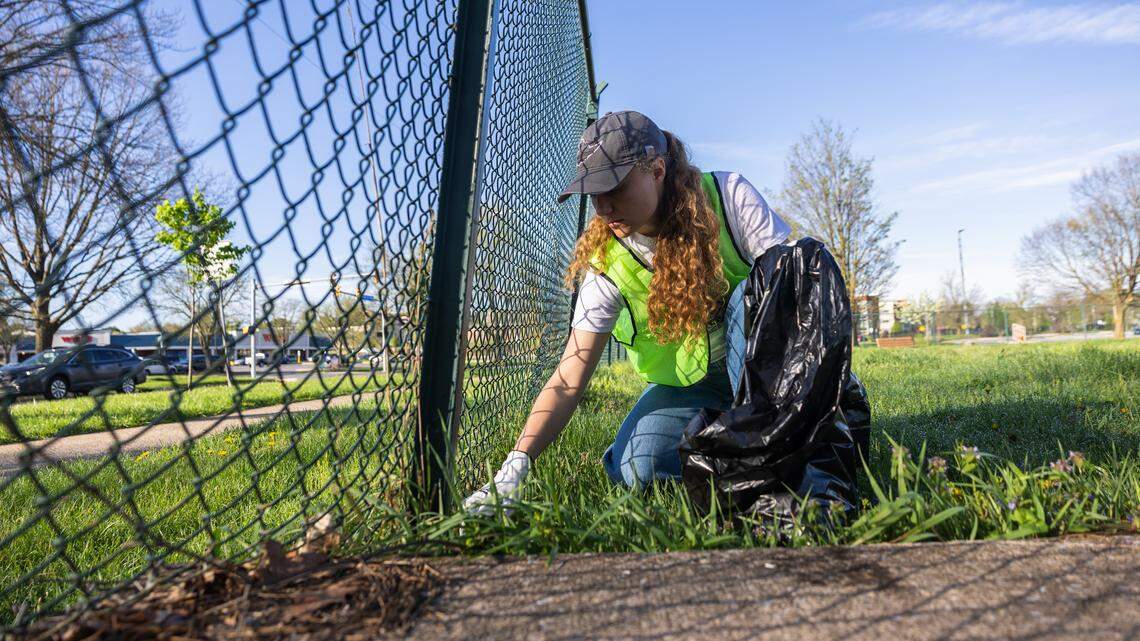 Leigh Fehlman, a water specialist, collects trash in a park off Westerly Parkway in State College, Pa., on Saturday, April 18, 2026. The Clearwater Conservancy organized volunteers across Centre County to clean up public green spaces.