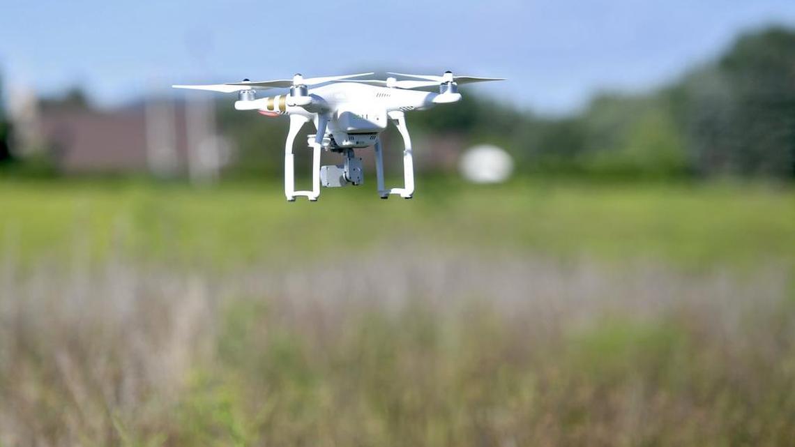 Mitchell Lester flies his drone over a field on Tuesday.