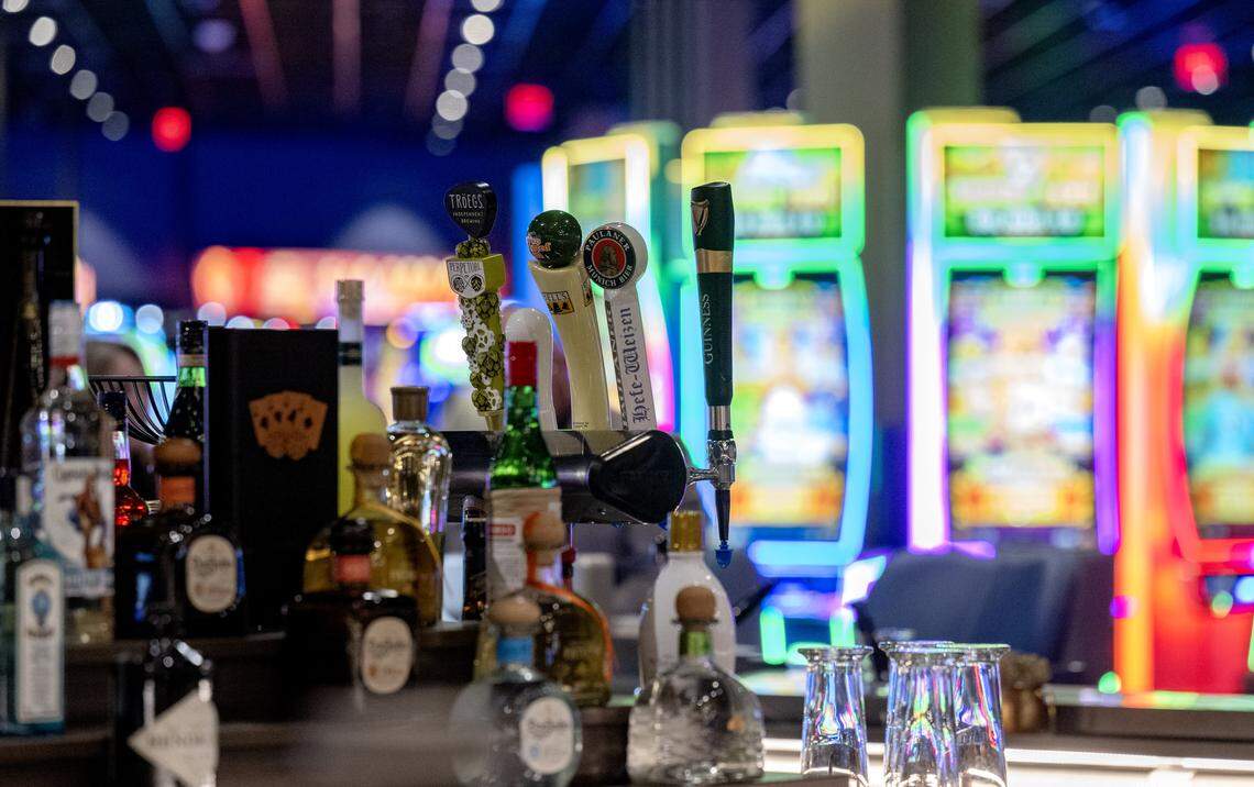 The slot machines glow behind the bar in Happy Valley Casino on Thursday, April 23, 2026, during a media tour.  