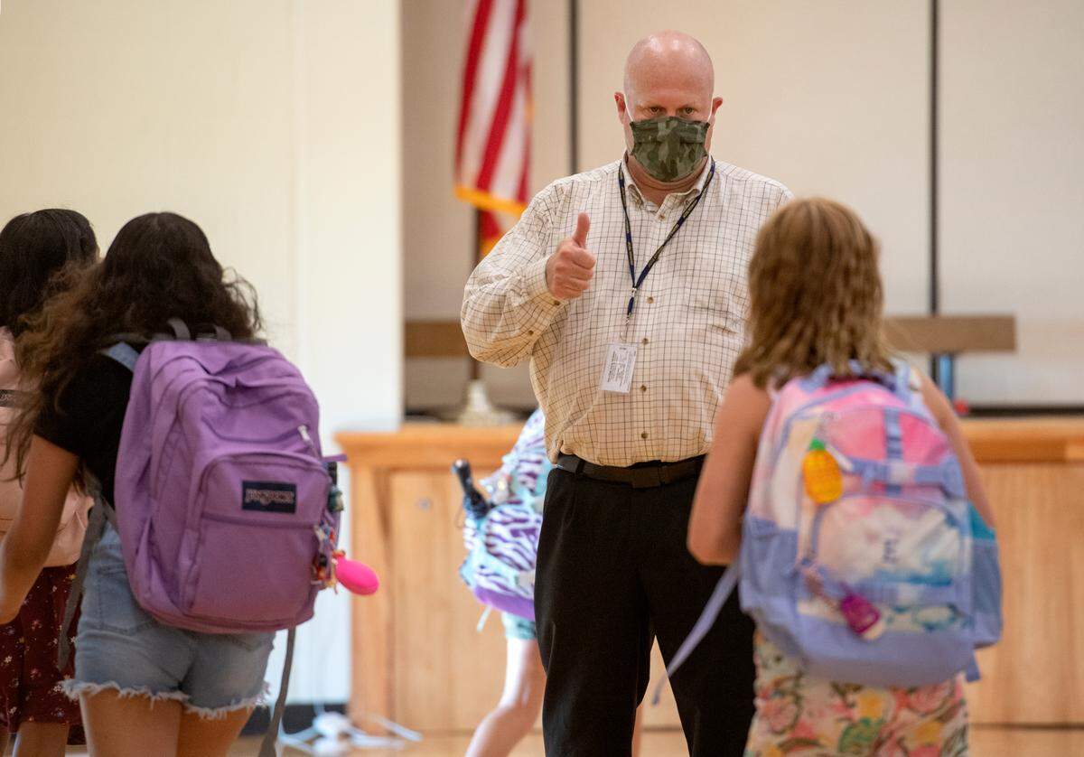 Mount Nittany Elementary principal Mark Feldman welcomes fifth graders to the first day of school on Tuesday.
