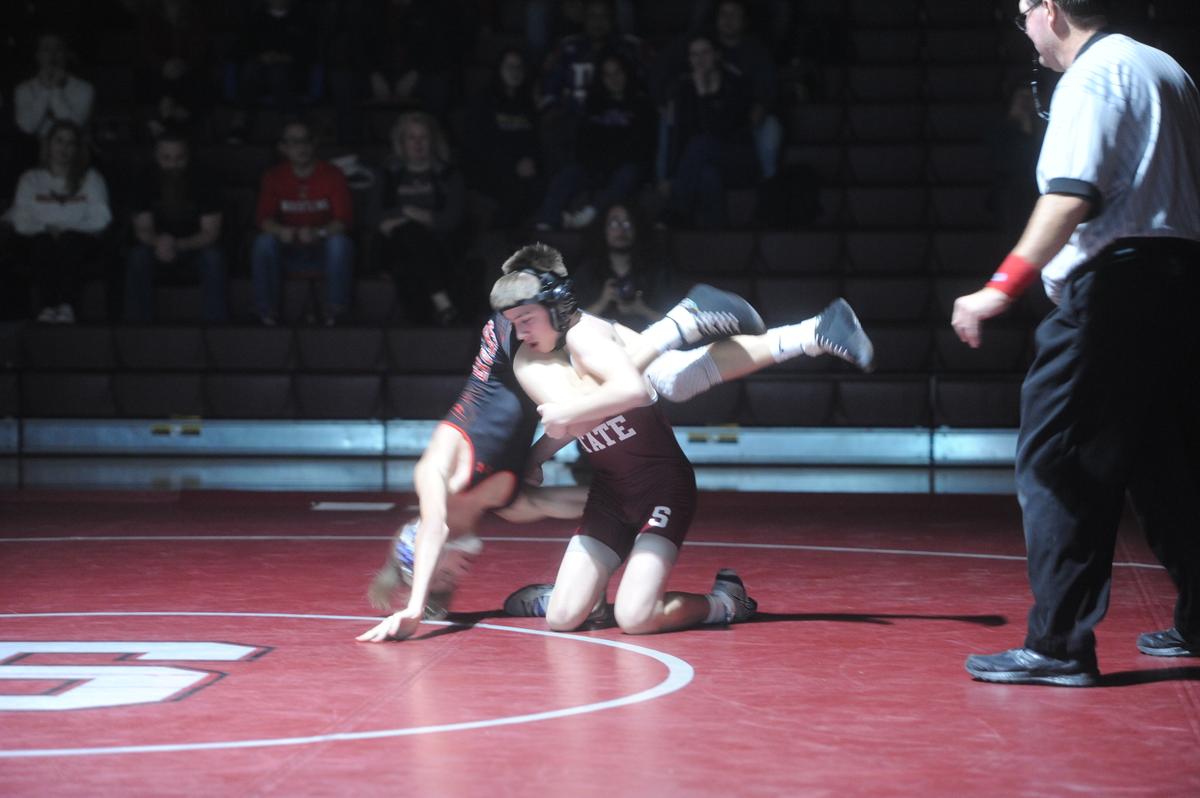 State College’s Mason Sanderson aims to finish off a takedown of Cumberland Valley’s Owen Whittaker in their 114-pound match of the Little Lions’ 40-29 loss on Wednesday, January 11, 2023. Sanderson edged Whittaker, 3-1.