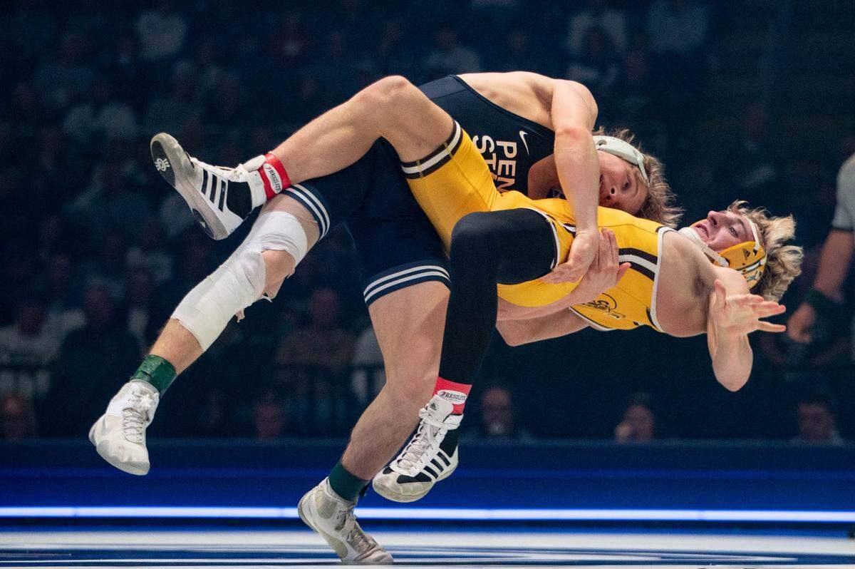 At 133, Braeden Davis, left, wrestles Stockton O’Brien, right, during the dual meet between Penn State and Wyoming on Sunday, Dec. 15, 2024.