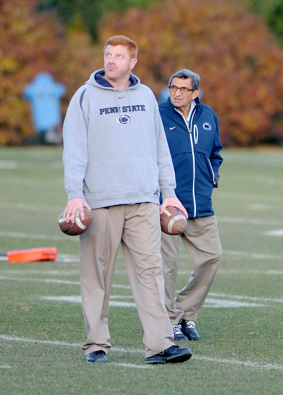 Penn State football coach Joe Paterno and Mike McQueary watch a ball from a kicker during practice on Wednesday, November 9, 2011.