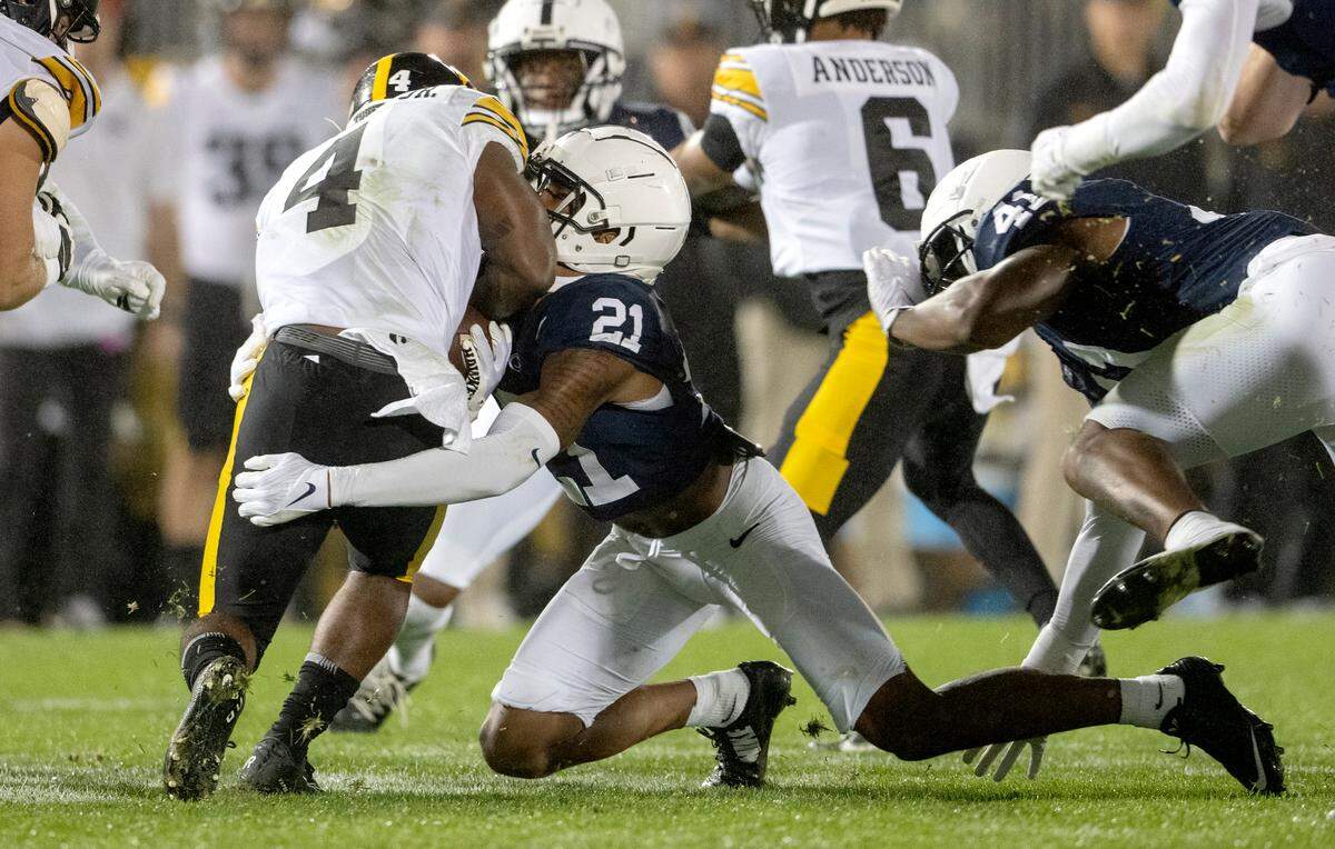 Penn State safety K.J. Winston stops Iowa’s Leshon Williams during the game on Saturday, Sept. 23, 2023.