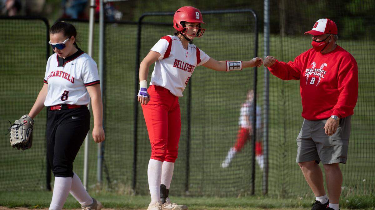 Bellefonte softball player Madison Melius fist bumps a coach during a 2021 game against Clearfield.