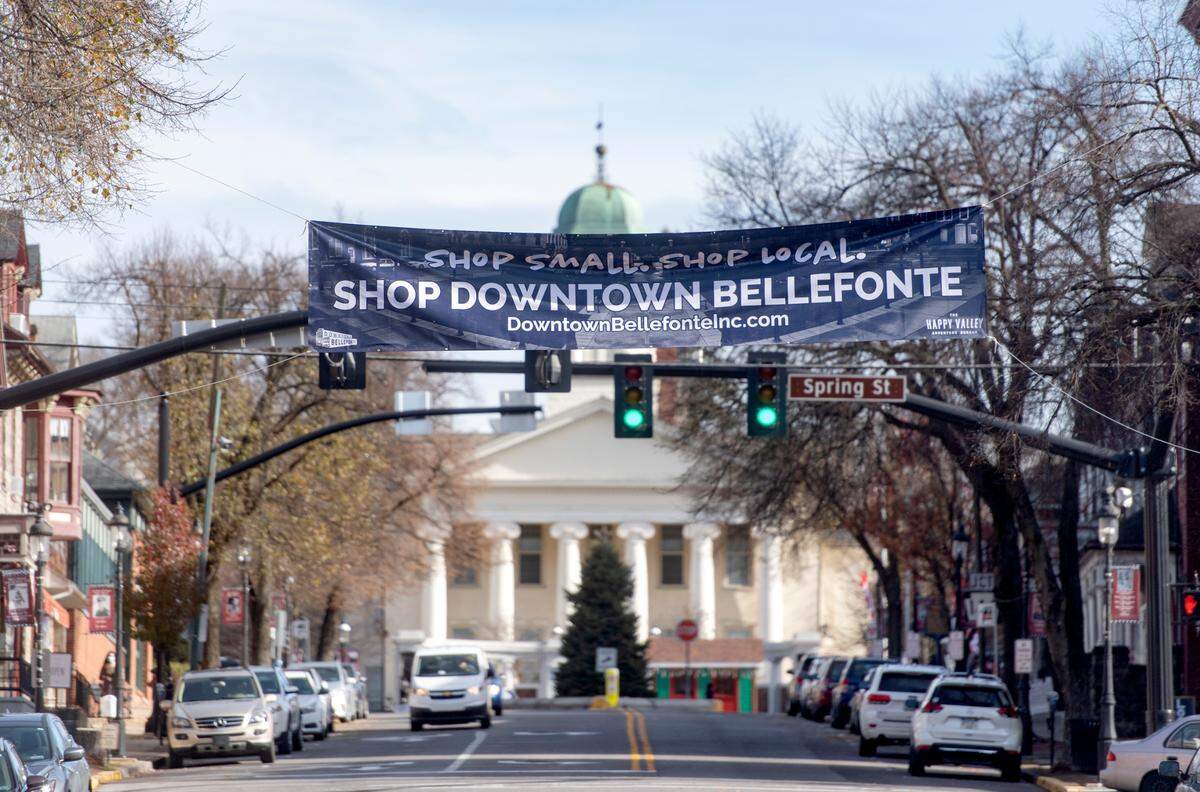 A sign encouraging visitors to shop local hangs in downtown Bellefonte on Thursday, Nov. 19, 2020.