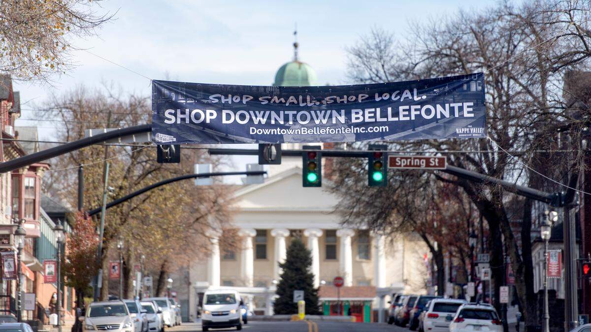 A sign promoting to shop small, shop local, shop downtown Bellefonte hangs over High Street on Thursday, Nov. 19, 2020.  