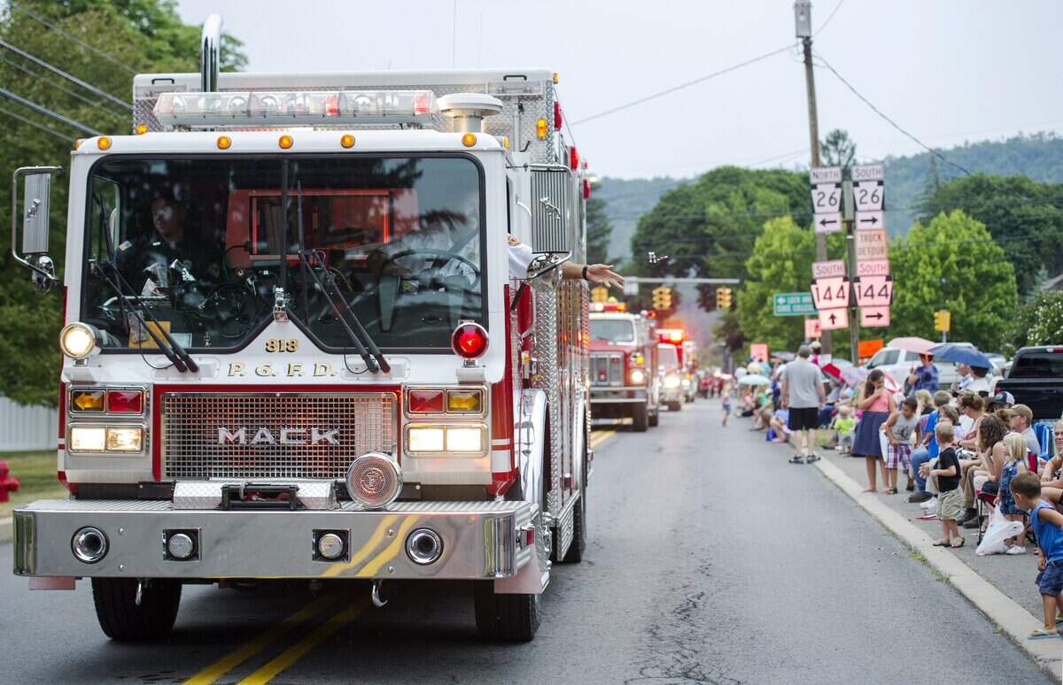 Members of the Pleasant Gap Fire Company throw Tootsie Rolls from their fire engine during the company's annual parade through Pleasant Gap in 2016.